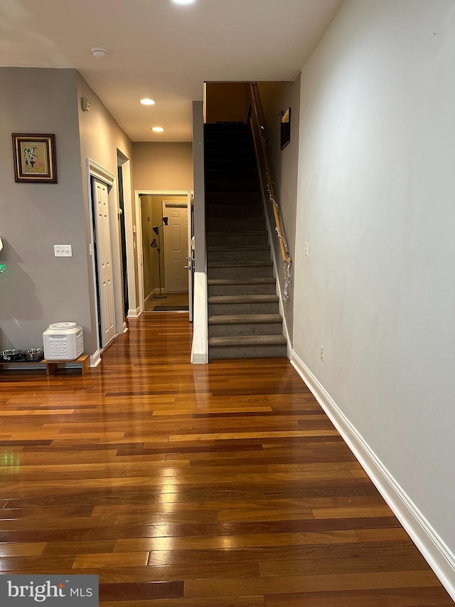 staircase featuring hardwood / wood-style floors