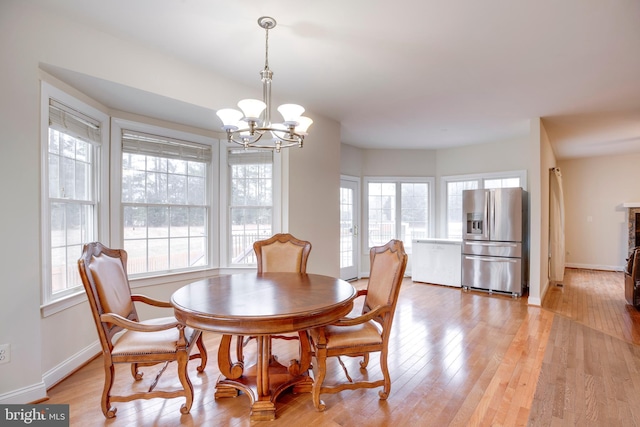 dining room featuring light hardwood / wood-style floors and an inviting chandelier