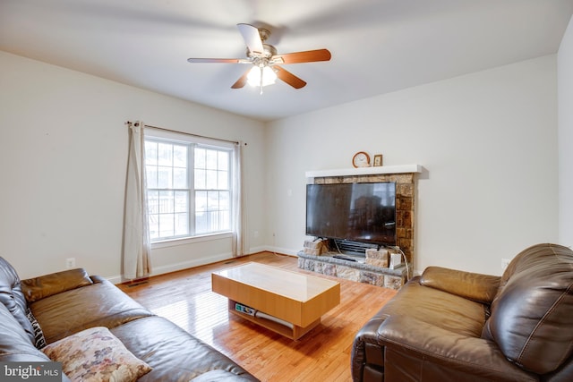 living room featuring ceiling fan and light hardwood / wood-style floors