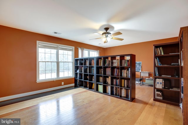 sitting room with ceiling fan and light hardwood / wood-style flooring