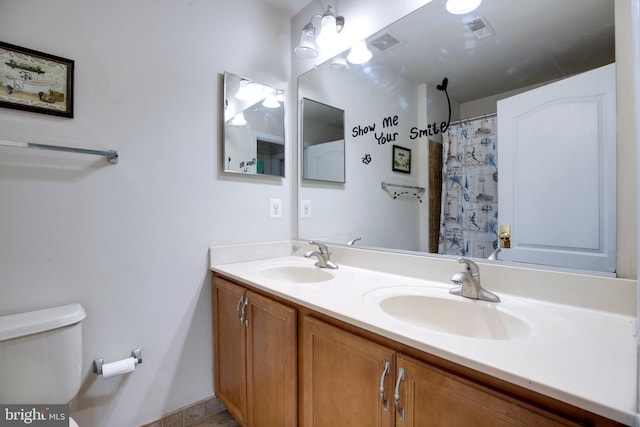 bathroom with vanity, a shower with curtain, and toilet