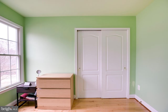 bedroom featuring light hardwood / wood-style flooring and a closet