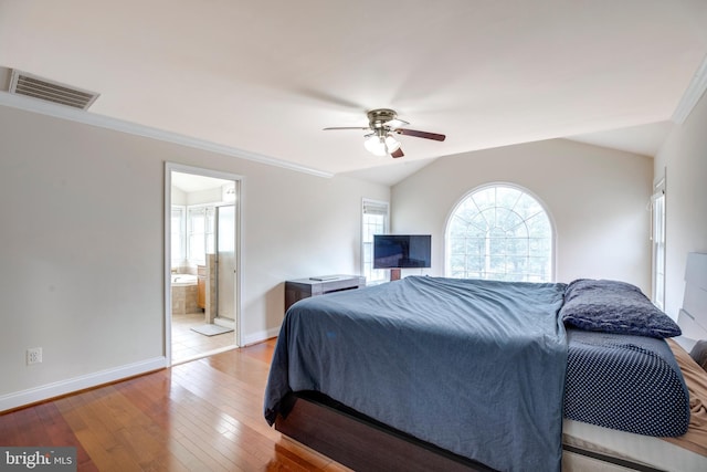 bedroom with ensuite bath, ceiling fan, vaulted ceiling, crown molding, and light wood-type flooring