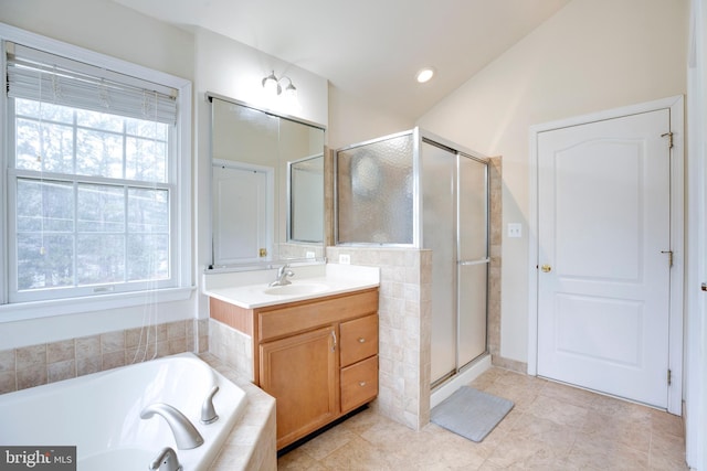 bathroom with tile patterned floors, separate shower and tub, and vanity