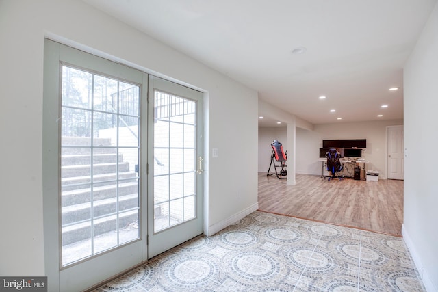 entryway with wood-type flooring and a healthy amount of sunlight