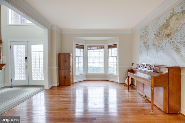 entryway featuring light wood-type flooring, french doors, and plenty of natural light