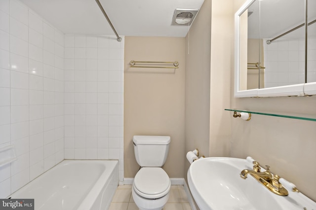 full bathroom with tile patterned flooring, tiled shower / bath combo, sink, and toilet