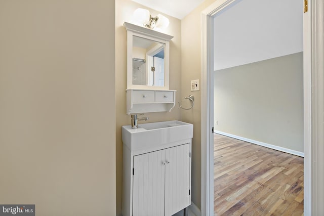 laundry area featuring sink and light wood-type flooring