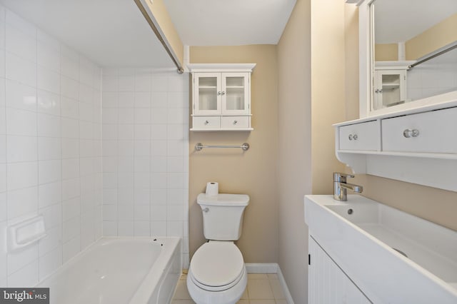 full bathroom with vanity, tiled shower / bath combo, tile patterned floors, and toilet