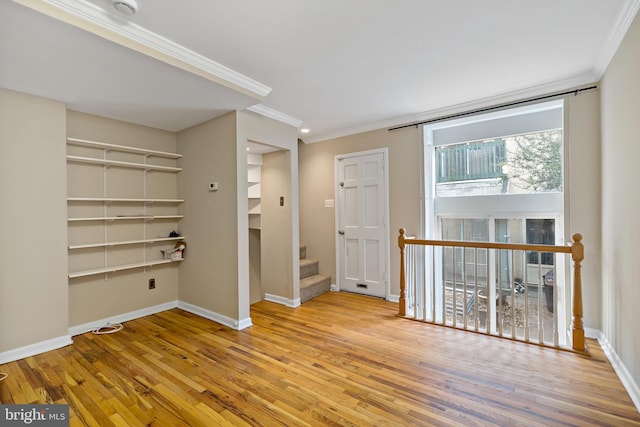 unfurnished room featuring ornamental molding and light wood-type flooring