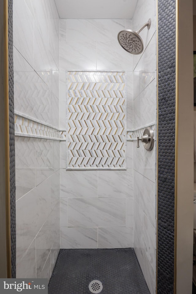 bathroom with tiled shower