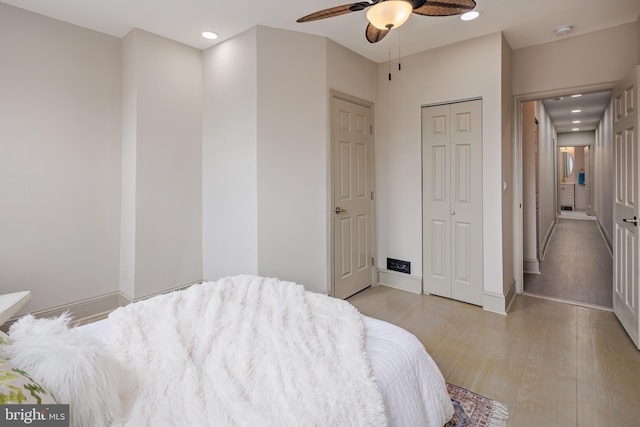 bedroom with baseboards, a ceiling fan, light wood-style floors, a closet, and recessed lighting