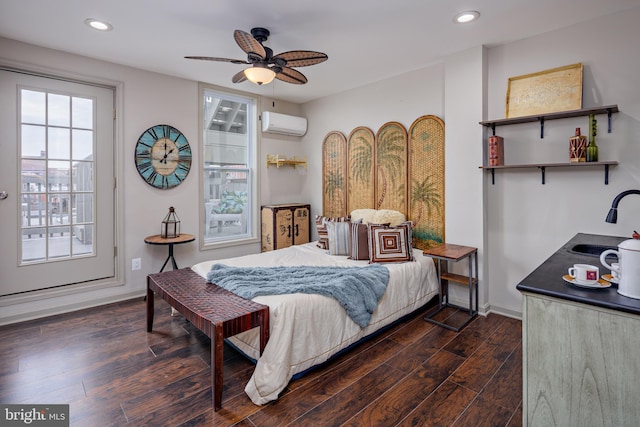 bedroom featuring baseboards, dark wood-style flooring, a wall unit AC, and recessed lighting