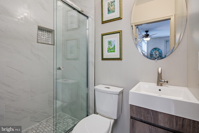 bathroom featuring a stall shower, vanity, and toilet