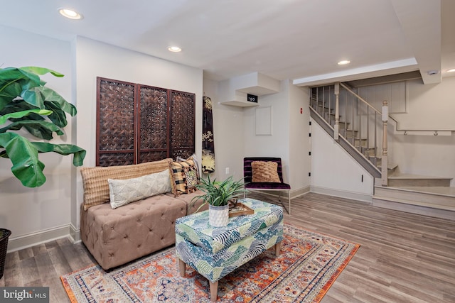 living room featuring recessed lighting, stairway, baseboards, and wood finished floors