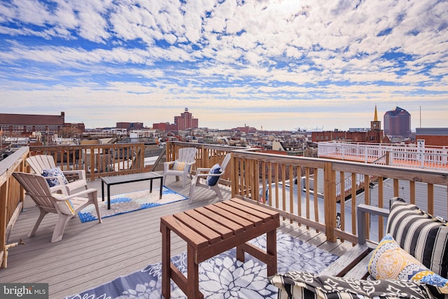 deck at dusk featuring a view of city