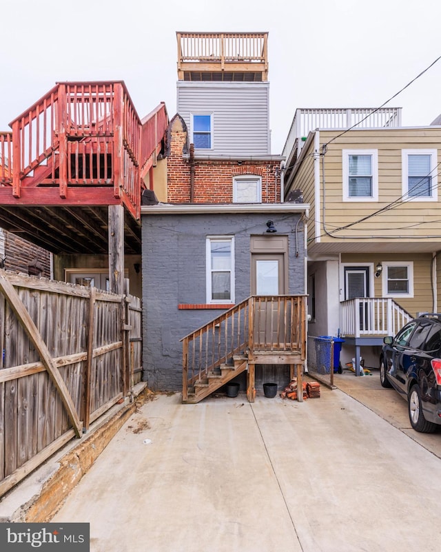 back of property with brick siding and fence