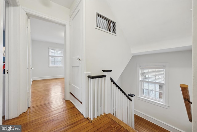 stairs with hardwood / wood-style flooring