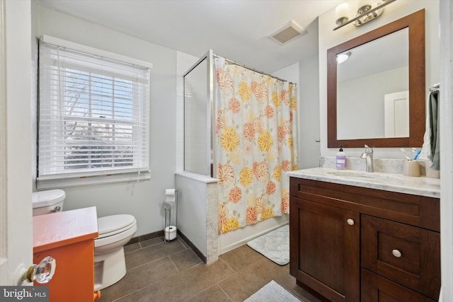 bathroom featuring tile patterned flooring, vanity, and toilet