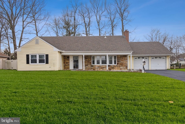 single story home featuring aphalt driveway, fence, roof with shingles, a front lawn, and a chimney