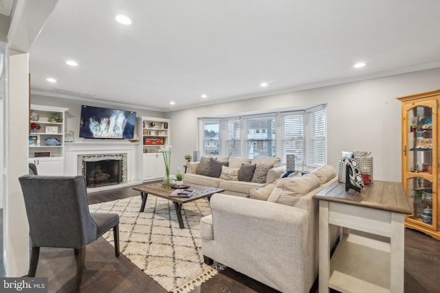 living area with crown molding, a fireplace, wood finished floors, and recessed lighting