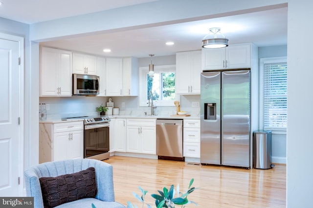12452 White Horse Rd, Lusby, MD 20657 - kitchen featuring light wood-style flooring, recessed lighting, light countertops, white cabinets, and appliances with stainless steel finishes