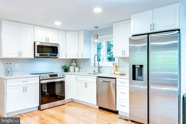 12452 White Horse Rd, Lusby, MD 20657 - kitchen featuring light wood finished floors, recessed lighting, a sink, stainless steel appliances, and white cabinetry