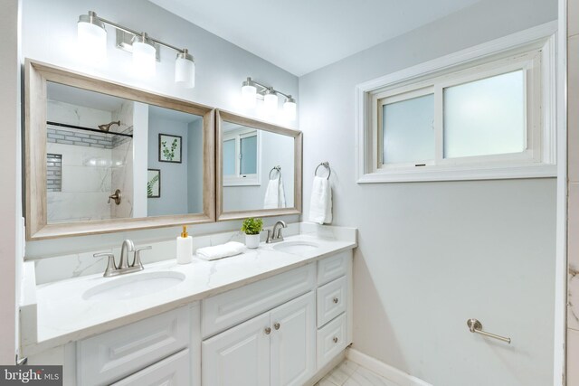 12452 White Horse Rd, Lusby, MD 20657 - full bath with double vanity, a shower, baseboards, and a sink