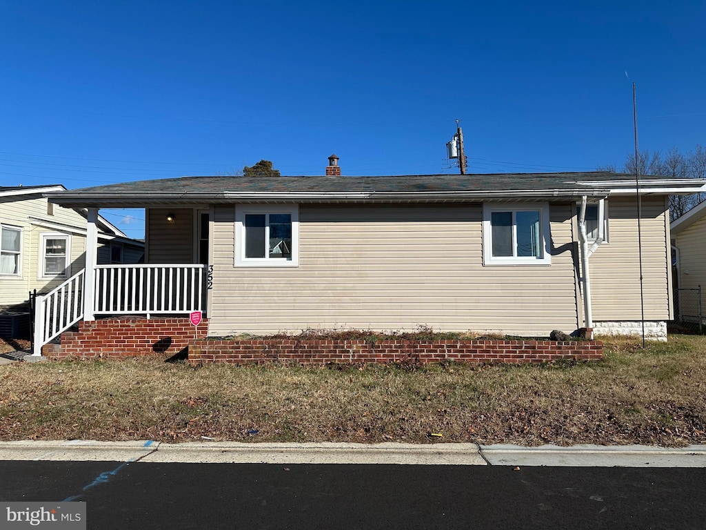 view of side of property with a porch