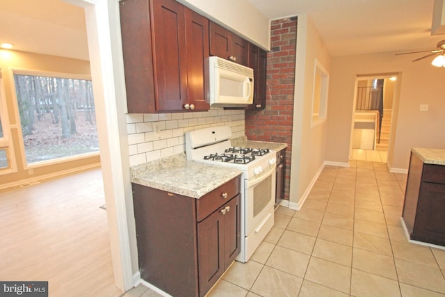 kitchen with backsplash, white appliances, light tile patterned floors, and ceiling fan