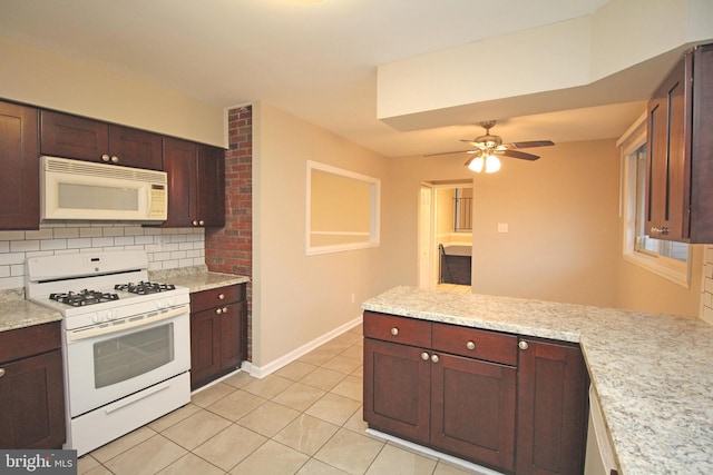 kitchen with white appliances, ceiling fan, backsplash, light tile patterned flooring, and kitchen peninsula