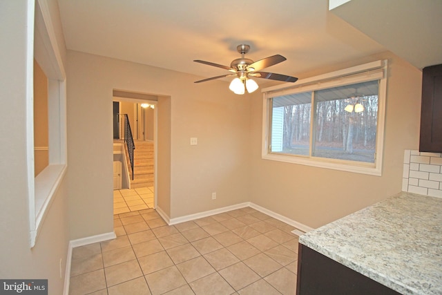 tiled dining area with ceiling fan