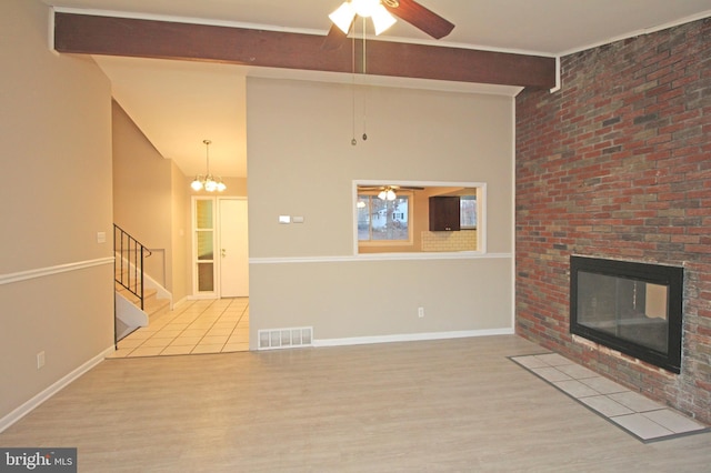 unfurnished living room featuring ceiling fan, a fireplace, and light wood-type flooring