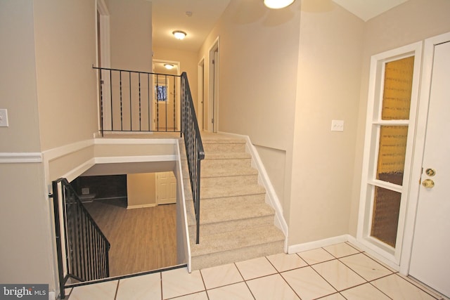 stairs featuring tile patterned floors