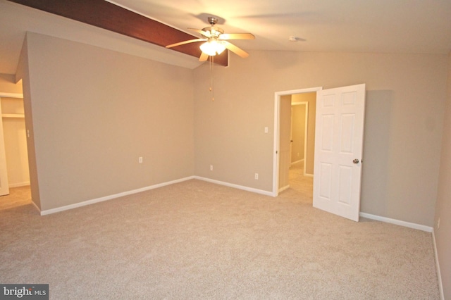 unfurnished bedroom with ceiling fan, light colored carpet, and vaulted ceiling