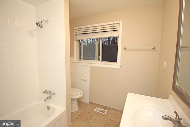 full bathroom featuring tile patterned floors, toilet, tiled shower / bath, tile walls, and vanity