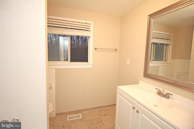 bathroom featuring vanity and toilet