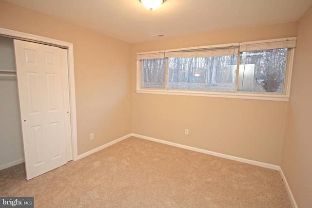 unfurnished bedroom featuring a closet and carpet flooring