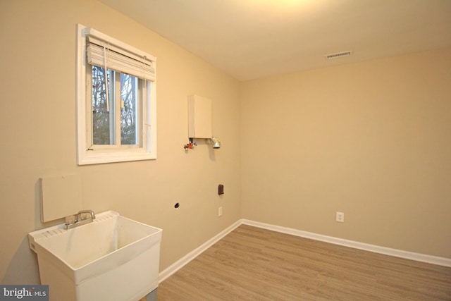 washroom with wood-type flooring and sink