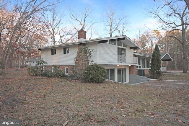 view of property exterior with a sunroom