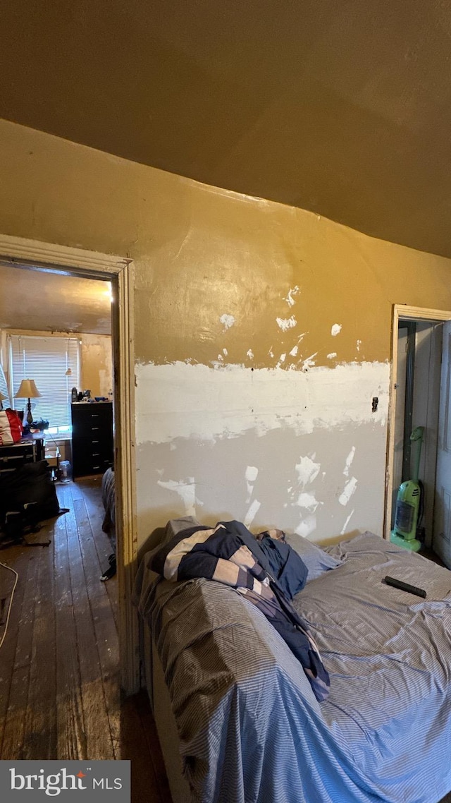 bedroom with dark wood-type flooring