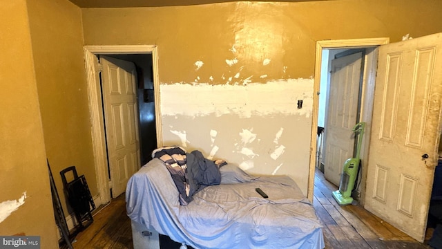 bedroom with dark wood-type flooring