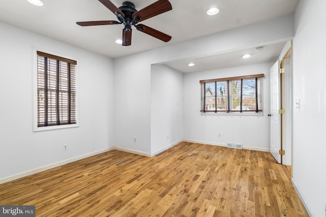 empty room with a ceiling fan, visible vents, baseboards, recessed lighting, and light wood-style floors