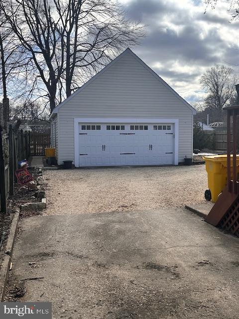 detached garage featuring fence