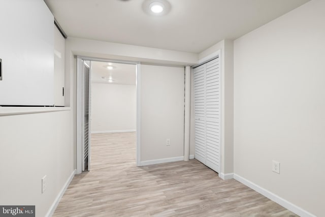 interior space featuring wood finished floors and baseboards