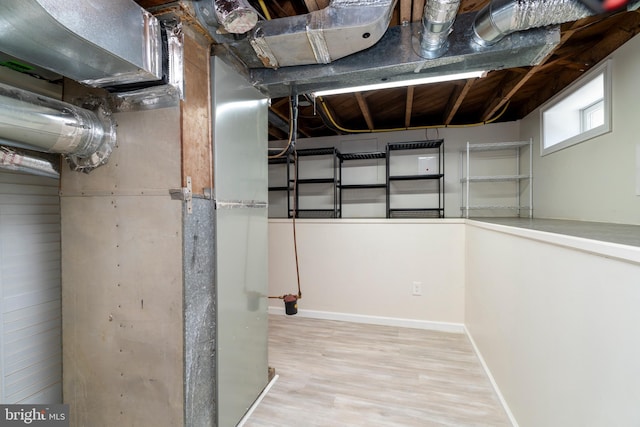 below grade area featuring wood finished floors and baseboards