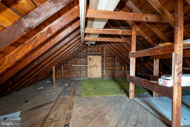 unfinished attic with an upstairs landing