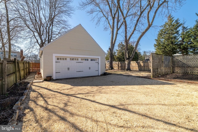 detached garage featuring fence