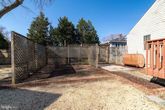 view of yard with heating fuel and a fenced backyard