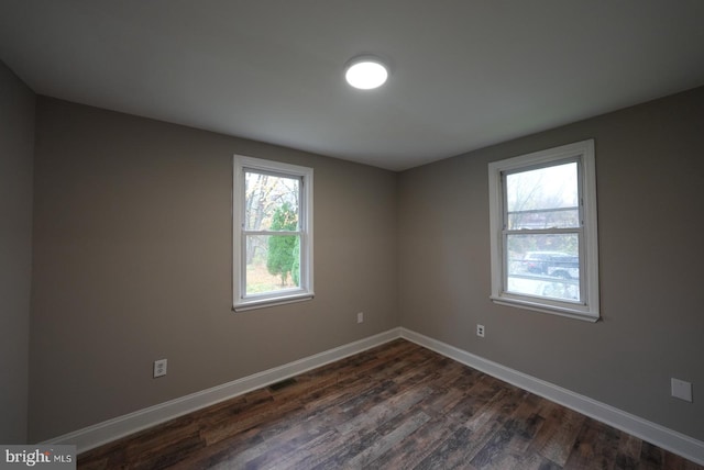 unfurnished room featuring dark hardwood / wood-style floors